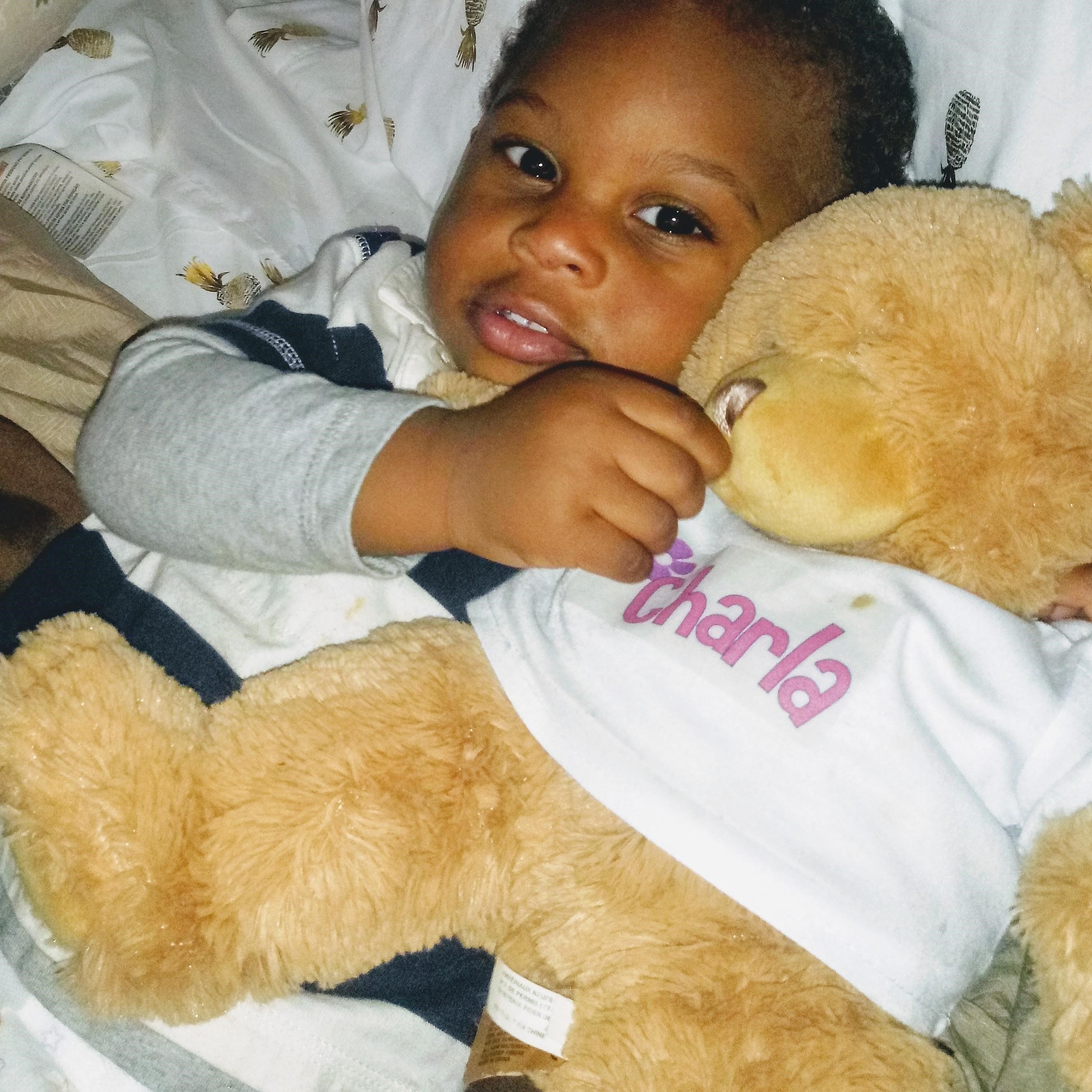 baby holding teddy bear