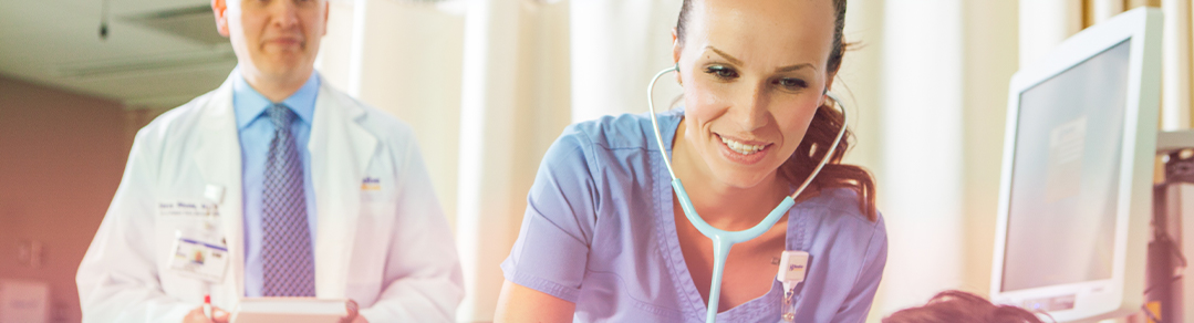 nurse checking a patient's heartbeat with a doctor taking notes