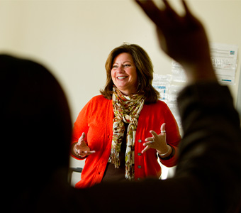 Woman presenting to class of peers.