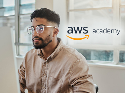 Man at a monitor with AWS Academy logo