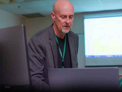 male teacher in a computer classroom