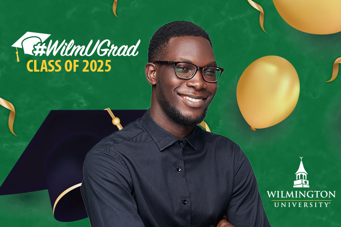 A monitor background image of a WilmU graduate