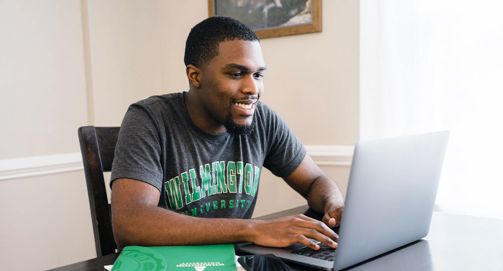 Man sitting at desk in front of computer