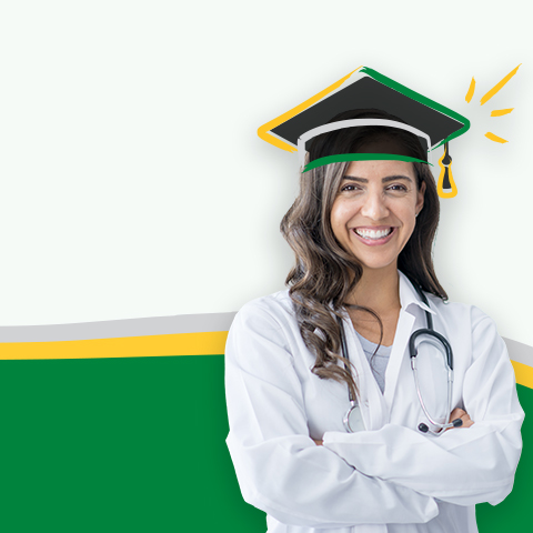 A woman wearing a medical coat, with her arms crossed and smiling with a graduation cap on her head
