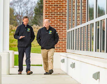 Two criminal justice institute personnel walking in front of the brandywine campus