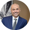 Man in suit smiling.