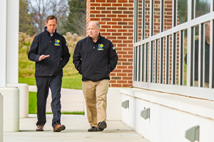 Two guards walking in front of a building