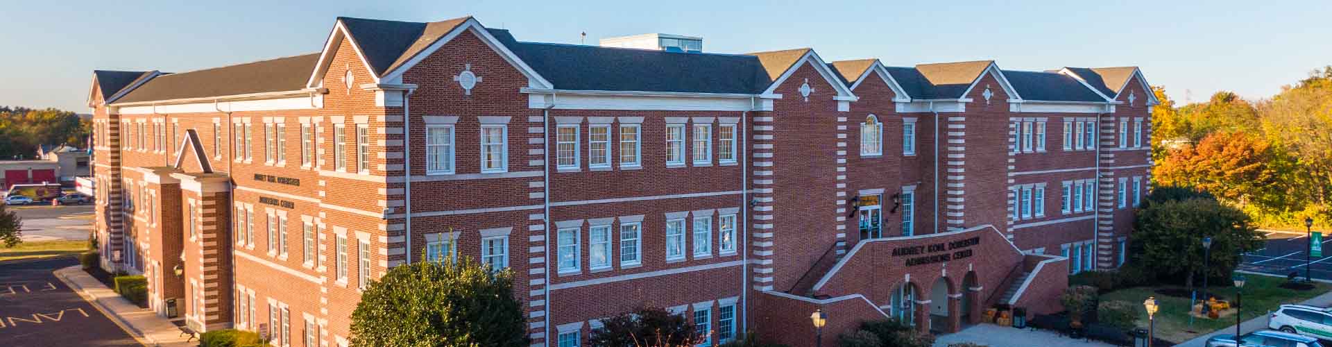 Women sitting at table working on her laptop.