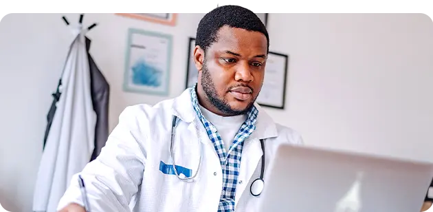 Medical worker working on a laptop.