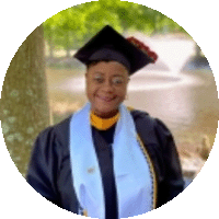 Person standing with graduation cap and gown