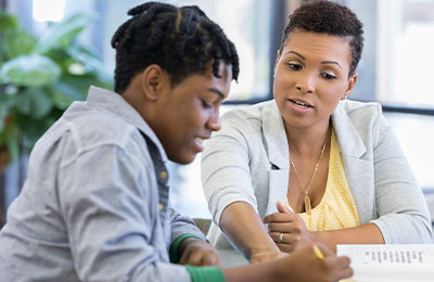 Instructor helping a student in office.