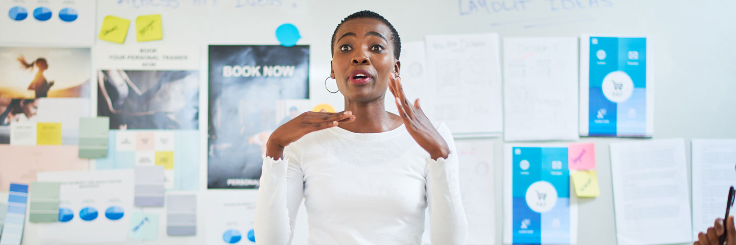 Information Technology Project Management Student talking in a classroom setting