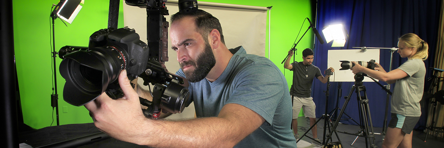 Student behind a large commercial camera