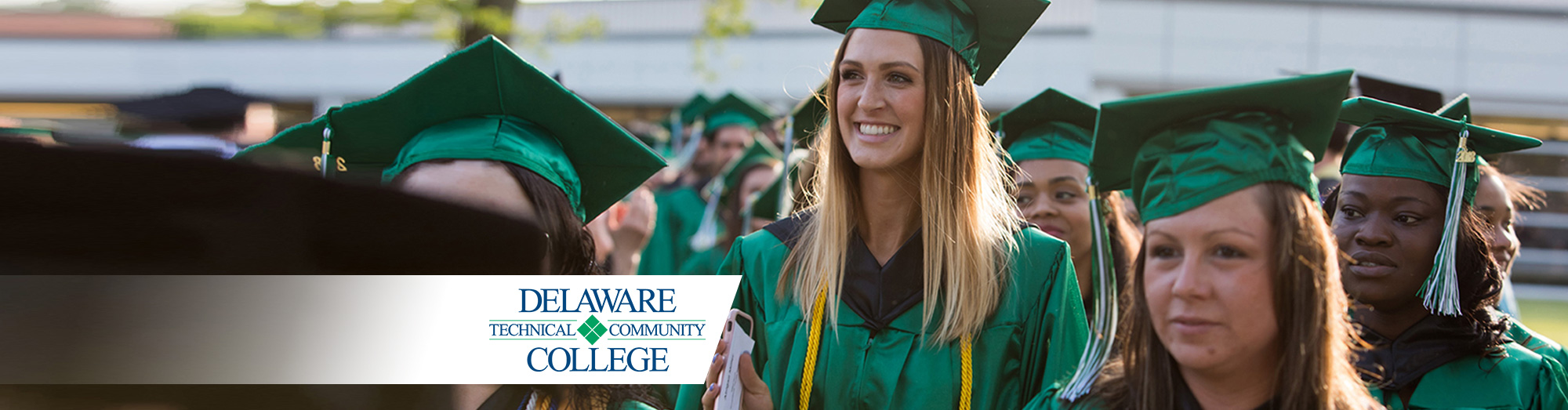 Students standing in graduation caps and gowns