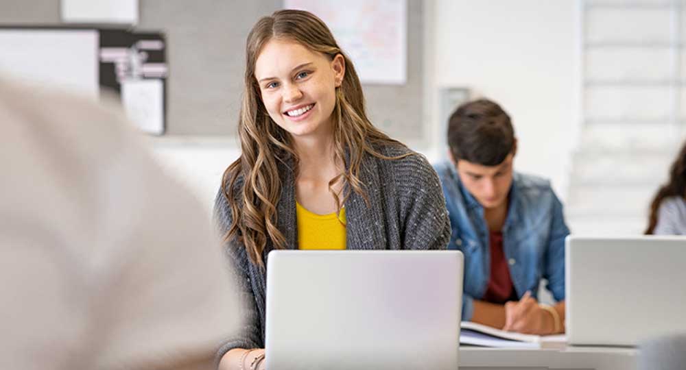 student sitting in front of laptop